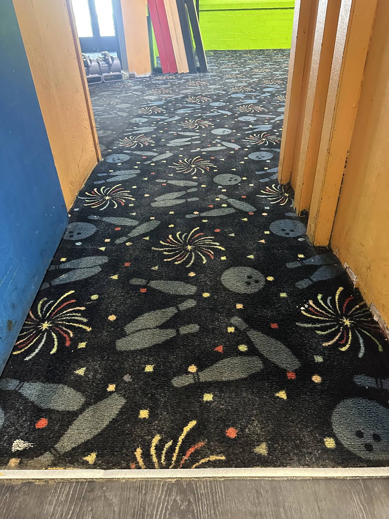 The same patterned entryway carpet restored to full color after cleaning