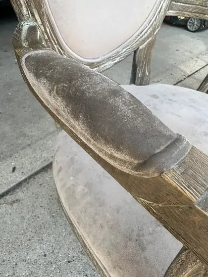 Close up of the same armchair armrest darkened with body oils and soil