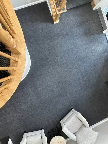 The same open room with clean even carpet after cleaning